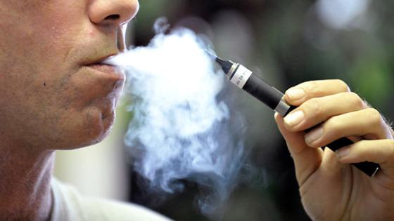 Tyler Bush, manager of The Vapor Bar in Grapevine, Texas, puffs on an electronic cigarette. "Vaping" is an alternative to tobacco smoking, and customers can pick liquids with their preferred flavors and nicotine levels. (Max Faulkner/Fort Worth Star-Telegram/MCT via Getty Images)